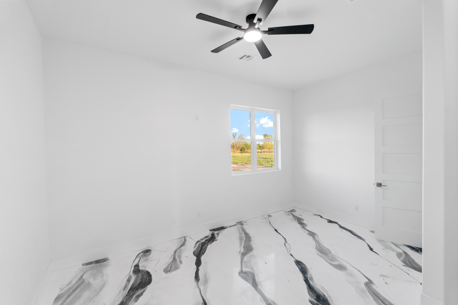 Primary bedroom with marble-epoxy floor