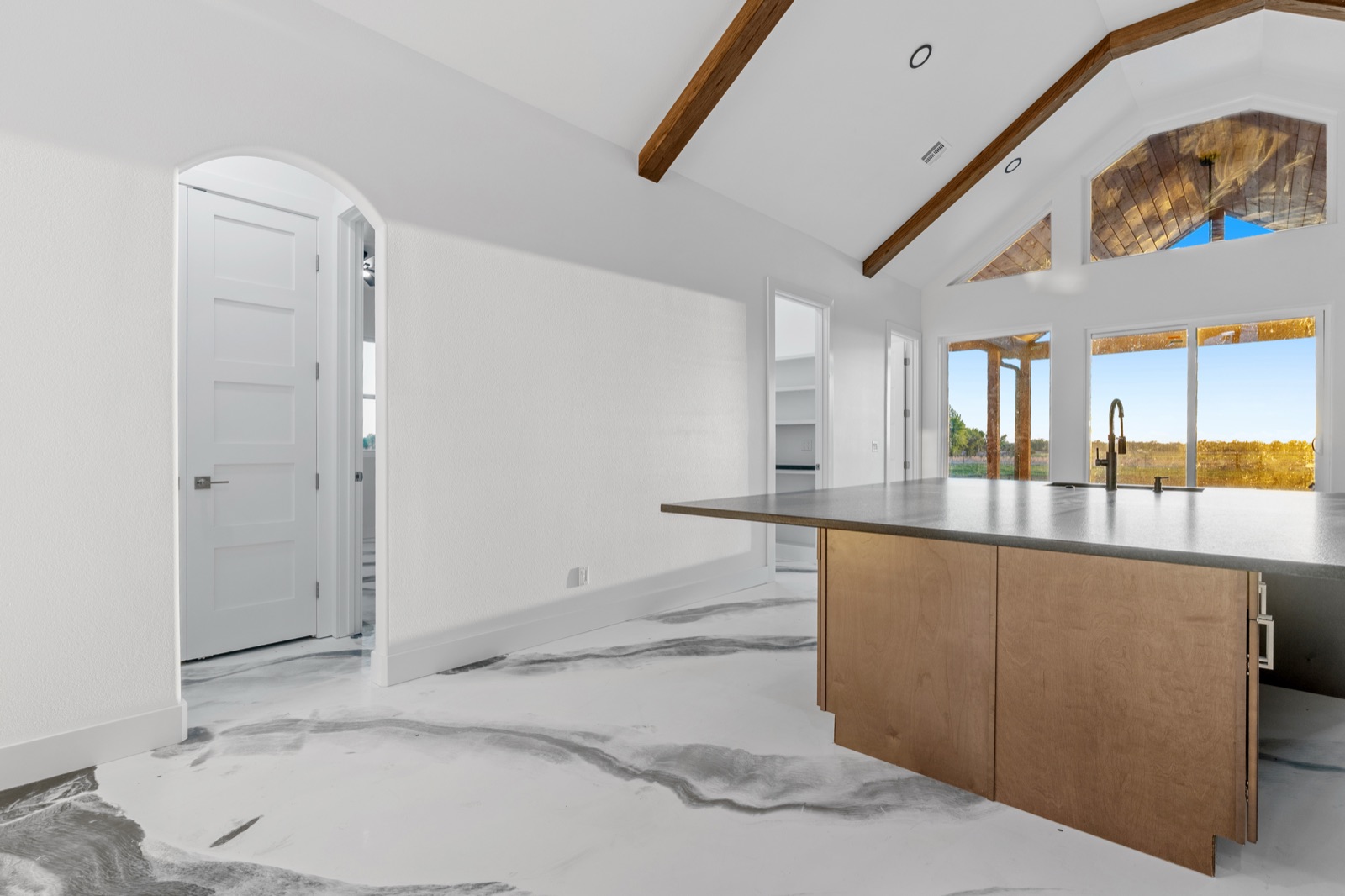 Vaulted great room with beam and island